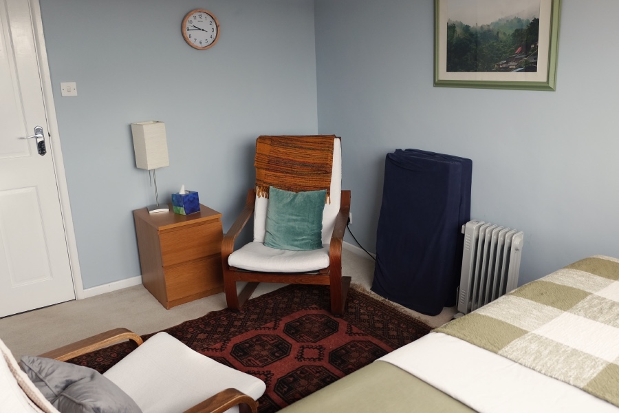 Cosy somatic therapy room in Lichfield with two chairs and massage table