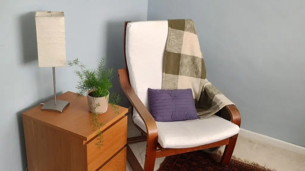 Calm psychotherapy room with cozy chair, cushions, and soft lighting for anxiety and depression support